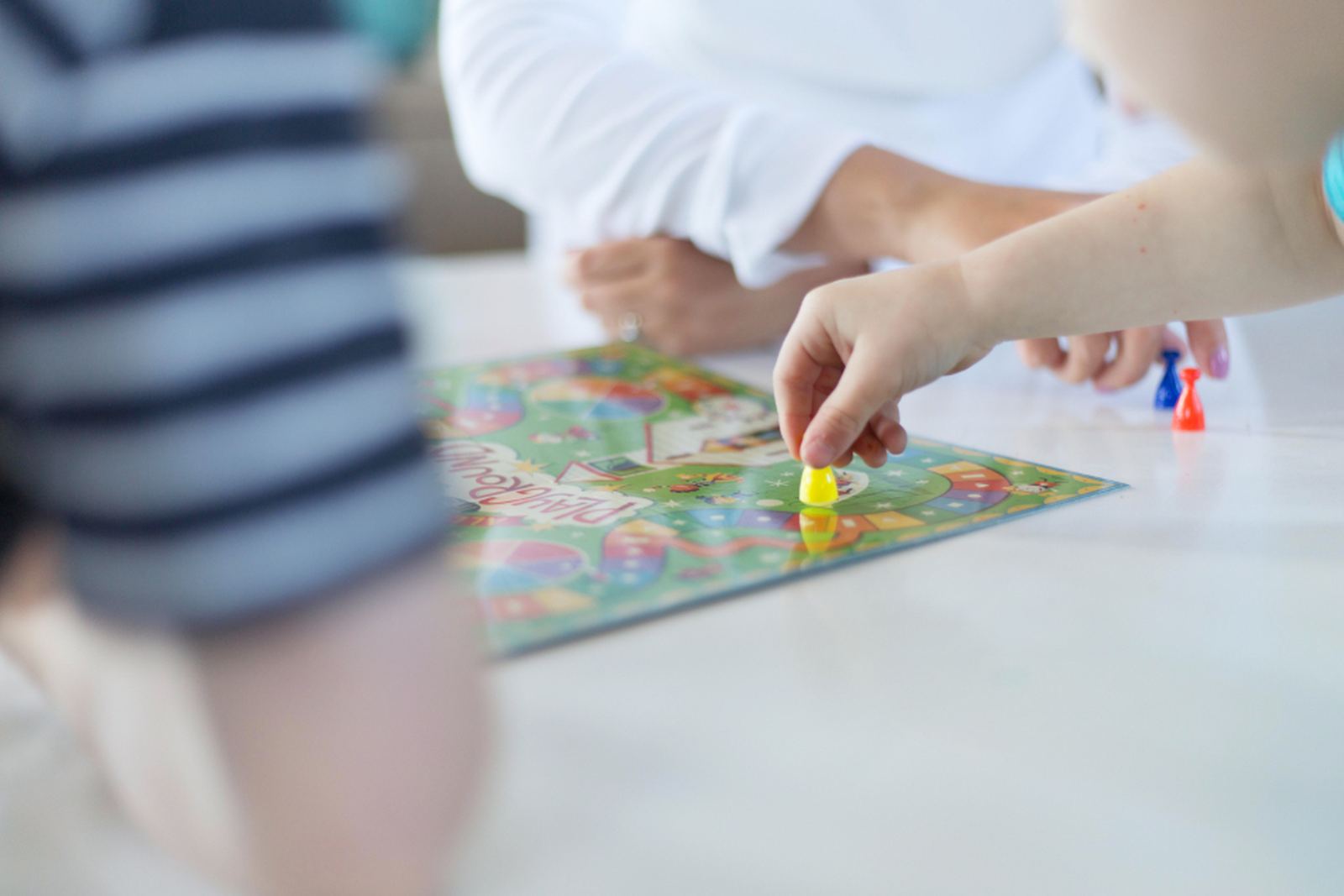 Children playing a board game at a table